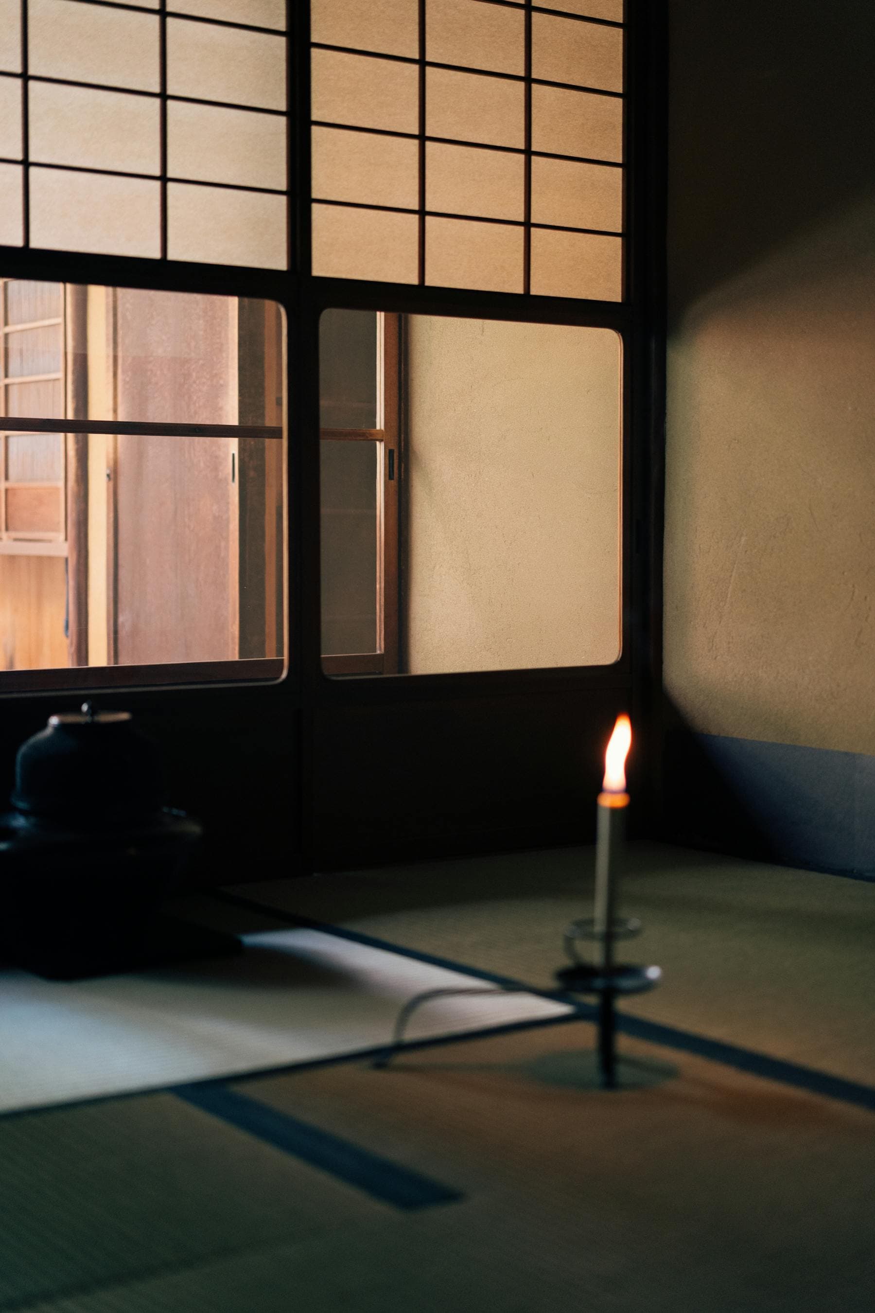 Quiet Japanese tea room interior with warm wood and low light